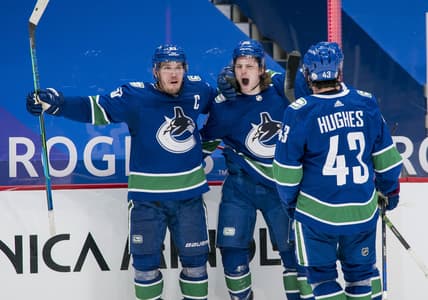 Mar 8, 2021; Vancouver, British Columbia, CAN; Vancouver Canucks forward Bo Horvat (53) and forward Adam Gaudette (96) and  forward J.T. Miller (9) and defenseman Quinn Hughes (43) celebrate Gaudette s goal against the Montreal Canadiens in the third period at Rogers Arena. Canucks won 2-1 in an overtime shootout. Mandatory Credit: Bob Frid-USA TODAY Sports
