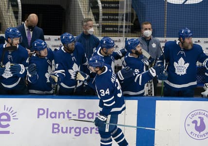 Apr 10, 2021; Toronto, Ontario, CAN; Toronto Maple Leafs center Auston Matthews (34) celebrates at the bench after scoring a third goal against the Ottawa Senators during the second period at Scotiabank Arena. Mandatory Credit: Nick Turchiaro-USA TODAY Sports