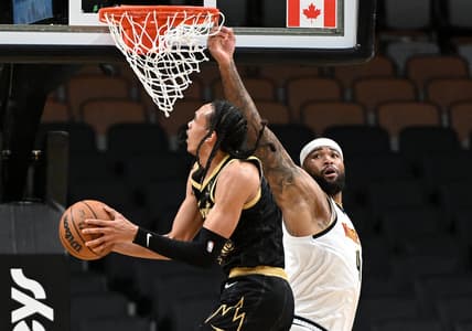 Feb 12, 2022; Toronto, Ontario, CAN;   Toronto Raptors guard Dalano Banton (45) drives for a lay up basket against Denver Nuggets center DeMarcus Cousins (4) in the first half at Scotiabank Arena. Mandatory Credit: Dan Hamilton-USA TODAY Sports