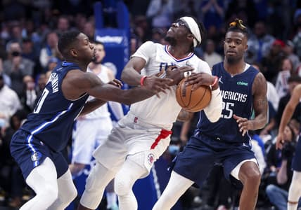 Feb 12, 2022; Dallas, Texas, USA;  Dallas Mavericks forward Dorian Finney-Smith (10) and forward Reggie Bullock (25) try to defend LA Clippers guard Reggie Jackson (1) during the fourth quarter at American Airlines Center. Mandatory Credit: Kevin Jairaj-USA TODAY Sports