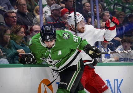 Nov 30, 2021; Dallas, Texas, USA; Dallas Stars center Tyler Seguin (91) checks Carolina Hurricanes defenseman Ian Cole (28) during the second period at the American Airlines Center. Mandatory Credit: Jerome Miron-USA TODAY Sports