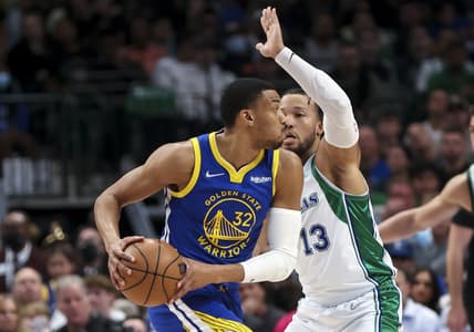 Mar 3, 2022; Dallas, Texas, USA;  Golden State Warriors forward Otto Porter Jr. (32) looks to pass as Dallas Mavericks guard Jalen Brunson (13) defends during the second quarter at American Airlines Center. Mandatory Credit: Kevin Jairaj-USA TODAY Sports