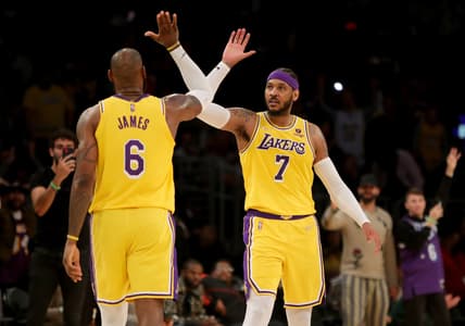 Mar 5, 2022; Los Angeles, California, USA; Los Angeles Lakers forward Carmelo Anthony (7) high-fives forward LeBron James (6) after Anthony made a three point basket in the fourth quarter against the Golden State Warriors at Crypto.com Arena. The Lakers won 124-116. Mandatory Credit: Kiyoshi Mio-USA TODAY Sports