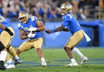 Nov 13, 2021; Pasadena, California, USA; UCLA Bruins quarterback Dorian Thompson-Robinson (1) hands the ball off to running back Zach Charbonnet (24) the first half against the Colorado Buffaloes at Rose Bowl. Mandatory Credit: Jayne Kamin-Oncea-USA TODAY Sports