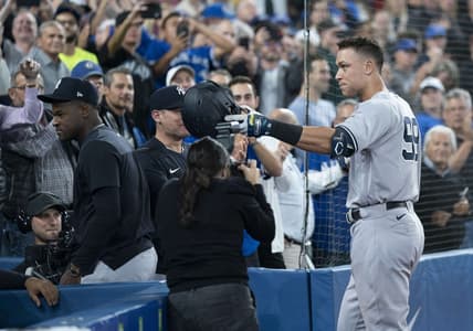 Sep 28, 2022; Toronto, Ontario, CAN; New York Yankees designated hitter Aaron Judge (99) tips his helmet towards his mother after hitting his 61st home run scoring two runs against the Toronto Blue Jays during the seventh inning at Rogers Centre. Mandatory Credit: Nick Turchiaro-USA TODAY Sports