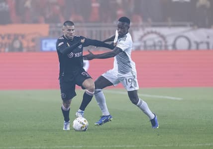 Sep 30, 2022; Toronto, Ontario, CAN; Toronto FC defender Richie Laryea (19) battles for the ball with Inter Miami midfielder Alejandro Pozuelo (8) during the first half at BMO Field. Mandatory Credit: Nick Turchiaro-USA TODAY Sports