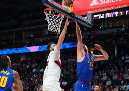 Dec 23, 2022; Denver, Colorado, USA; Denver Nuggets center Nikola Jokic (15) shoots past Portland Trail Blazers center Jusuf Nurkic (27) in the first quarter at Ball Arena. Mandatory Credit: Ron Chenoy-USA TODAY Sports