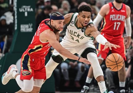 Jan 29, 2023; Milwaukee, Wisconsin, USA; Milwaukee Bucks forward Giannis Antetokounmpo (34) and New Orleans Pelicans guard Jose Alvarado (15) reach for a loose ball in the first quarter at Fiserv Forum. Mandatory Credit: Benny Sieu-USA TODAY Sports