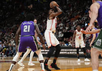 Jan 14, 2023; Miami, Florida, USA;  Miami Heat center Bam Adebayo (13) shoots the ball against Milwaukee Bucks guard Jrue Holiday (21) during the second half at Miami-Dade Arena. Mandatory Credit: Jim Rassol-USA TODAY Sports