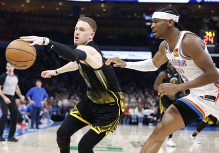 Mar 7, 2023; Oklahoma City, Oklahoma, USA; Golden State Warriors guard Donte DiVincenzo (0) reaches for a loose ball in front of Oklahoma City Thunder guard Shai Gilgeous-Alexander (2) during the second quarter at Paycom Center. Mandatory Credit: Alonzo Adams-USA TODAY Sports