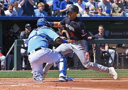 Apr 2, 2023; Kansas City, Missouri, USA; Minnesota Twins left fielder Trevor Larnach (9) is tagged out at home plate by Kansas City Royals catcher Salvador Perez (13) during the second inning at Kauffman Stadium. Mandatory Credit: Peter Aiken-USA TODAY Sports
