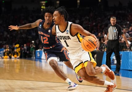 Mar 16, 2023; Birmingham, AL, USA;  Iowa Hawkeyes guard Ahron Ulis (1) drives around Auburn Tigers guard Zep Jasper (12) during the first half in the first round of the 2023 NCAA Tournament at Legacy Arena. Mandatory Credit: Marvin Gentry-USA TODAY Sports