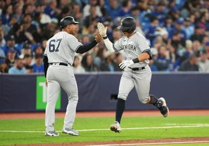 May 18, 2023; Toronto, Ontario, CAN; New York Yankees shortstop Anthony Volpe (11) hits a home run and celebrates with third base coach Luis Rojas (67) against the Toronto Blue Jays during the ninth inning at Rogers Centre. Mandatory Credit: Nick Turchiaro-USA TODAY Sports