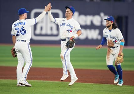 Jun 7, 2023; Toronto, Ontario, CAN; Toronto Blue Jays third baseman Matt Chapman (26) celebrates the win with Toronto Blue Jays second baseman Whit Merrifield (15) against the Houston Astros at the end of the ninth inning at Rogers Centre. Mandatory Credit: Nick Turchiaro-USA TODAY Sports