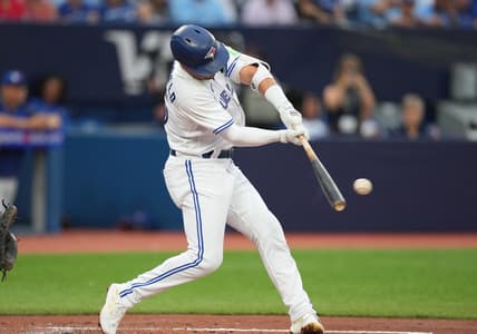 Jul 28, 2023; Toronto, Ontario, CAN; Toronto Blue Jays second baseman Whit Merrifield (15) hits a single against the Los Angeles Angels during the third inning at Rogers Centre. Mandatory Credit: Nick Turchiaro-USA TODAY Sports