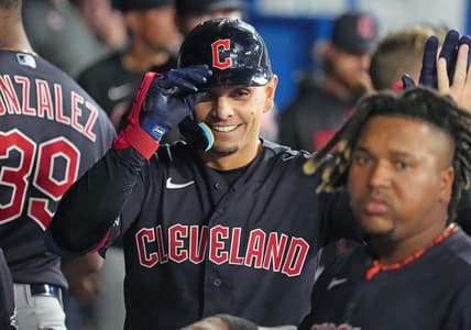 Aug 25, 2023; Toronto, Ontario, CAN; Cleveland Guardians second baseman Andres Gimenez (0) celebrates in the dugout after hitting a home run against the Toronto Blue Jays during the eighth inning at Rogers Centre. Mandatory Credit: Nick Turchiaro-USA TODAY Sports