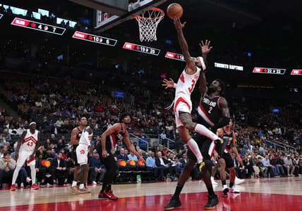 Oct 30, 2023; Toronto, Ontario, CAN; Toronto Raptors guard Gary Trent Jr. (33) drives to the basket over Portland Trail Blazers center Deandre Ayton (2) during the fourth quarter at Scotiabank Arena. Mandatory Credit: Nick Turchiaro-USA TODAY Sports