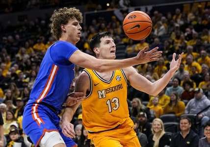 Jan 20, 2024; Columbia, Missouri, USA; Missouri Tigers forward Jesus Carralero Martin (13) loses control of the ball as he drives against Florida Gators center Micah Handlogten (3) during the first half at Mizzou Arena. Mandatory Credit: Jay Biggerstaff-USA TODAY Sports