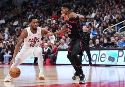 Feb 10, 2024; Toronto, Ontario, CAN; Cleveland Cavaliers guard Donovan Mitchell (45) controls the ball as Toronto Raptors guard Ochai Agbaji (30) tries to defend during the second quarter at Scotiabank Arena . Mandatory Credit: Nick Turchiaro-USA TODAY Sports
