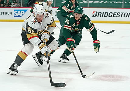 May 22, 2021; Saint Paul, Minnesota, USA; Vegas Golden Knights center Jonathan Marchessault (81) controls the puck against Minnesota Wild defenseman Jonas Brodin (25) during the first period in game four of the first round of the 2021 Stanley Cup Playoffs at Xcel Energy Center. Mandatory Credit: Nick Wosika-USA TODAY Sports