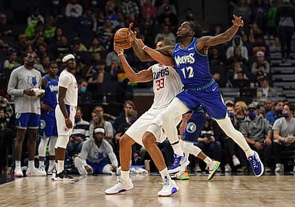 Nov 5, 2021; Minneapolis, Minnesota, USA; Minnesota Timberwolves forward Taurean Prince (12) attempts to steal a pass intended for Los Angeles Clippers forward Nicolas Batum (33) during the first quarter at Target Center. Mandatory Credit: Nick Wosika-USA TODAY Sports