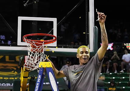 Mar 5, 2022; Waco, Texas, USA; Baylor forward Jeremy Sochan cuts down the net to celebrate the Bears regular season Big 12 Co-Championship following a victory over the Iowa State Cyclones at Ferrell Center. Mandatory Credit: Raymond Carlin III-USA TODAY Sports