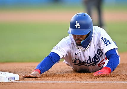 Jul 22, 2022; Los Angeles, California, USA;  Los Angeles Dodgers right fielder Mookie Betts (50) dives back to first on a pick off attempt in the first inning against the San Francisco Giants at Dodger Stadium. Mandatory Credit: Jayne Kamin-Oncea-USA TODAY Sports