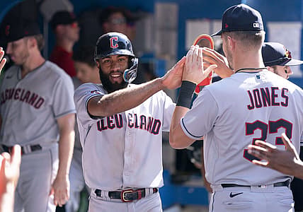 Aug 14, 2022; Toronto, Ontario, CAN; Cleveland Guardians shortstop Amed Rosario (1) celebrates in the dugout after scoring a run against the Toronto Blue Jays during the ninth inning at Rogers Centre. Mandatory Credit: Nick Turchiaro-USA TODAY Sports