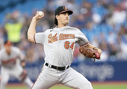 Aug 16, 2022; Toronto, Ontario, CAN; Baltimore Orioles starting pitcher Dean Kremer (64) throws a pitch against the Toronto Blue Jays during the first inning at Rogers Centre. Mandatory Credit: Nick Turchiaro-USA TODAY Sports