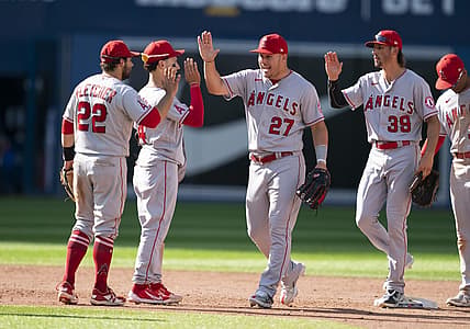 Aug 28, 2022; Toronto, Ontario, CAN; Los Angeles Angels center fielder Mike Trout (27) celebrates the win with Los Angeles Angels second baseman David Fletcher (22) against the Toronto Blue Jays at Rogers Centre. Mandatory Credit: Nick Turchiaro-USA TODAY Sports