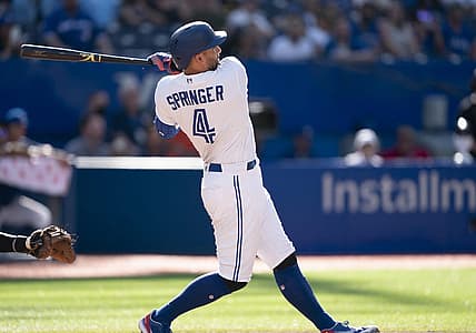 Aug 28, 2022; Toronto, Ontario, CAN; Toronto Blue Jays center fielder George Springer (4) hits a home run against the Los Angeles Angels during the ninth inning at Rogers Centre. Mandatory Credit: Nick Turchiaro-USA TODAY Sports