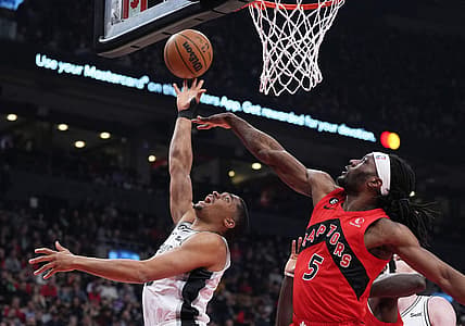 Feb 8, 2023; Toronto, Ontario, CAN; San Antonio Spurs forward Keldon Johnson (3) drives to the basket as Toronto Raptors forward Precious Achiuwa (5) tries to defend during the first quarter at Scotiabank Arena. Mandatory Credit: Nick Turchiaro-USA TODAY Sports