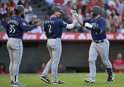 Aug 4, 2023; Anaheim, California, USA;  Seattle Mariners first baseman Ty France (23) is greeted by right fielder Teoscar Hernandez (35) and catcher Tom Murphy (2) after hitting a three run home run in the first inning against the Los Angeles Angels at Angel Stadium. Mandatory Credit: Jayne Kamin-Oncea-USA TODAY Sports