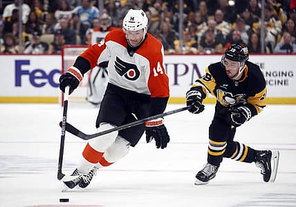 Dec 2, 2023; Pittsburgh, Pennsylvania, USA; Philadelphia Flyers center Sean Couturier (14) moves the puck up ice pat Pittsburgh Penguins right wing Reilly Smith (19) during the second period at PPG Paints Arena. Mandatory Credit: Charles LeClaire-USA TODAY Sports