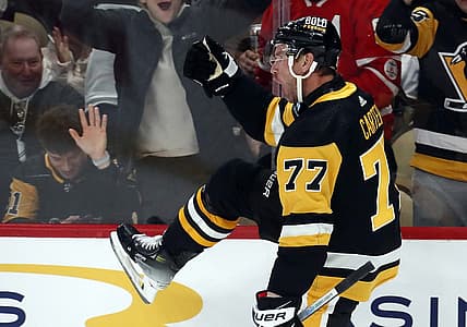 Dec 12, 2023; Pittsburgh, Pennsylvania, USA; Pittsburgh Penguins center Jeff Carter (77) reacts after scoring a short-handed goal against the Arizona Coyotes during the first period at PPG Paints Arena. Mandatory Credit: Charles LeClaire-USA TODAY Sports