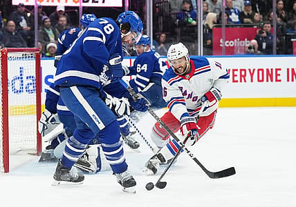 Dec 19, 2023; Toronto, Ontario, CAN; Toronto Maple Leafs defenseman TJ Brodie (78) battles for the puck with New York Rangers center Vincent Trocheck (16) during the second period at Scotiabank Arena. Mandatory Credit: Nick Turchiaro-USA TODAY Sports