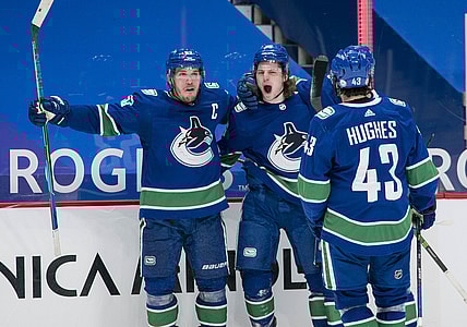 Mar 8, 2021; Vancouver, British Columbia, CAN; Vancouver Canucks forward Bo Horvat (53) and forward Adam Gaudette (96) and  forward J.T. Miller (9) and defenseman Quinn Hughes (43) celebrate Gaudette s goal against the Montreal Canadiens in the third period at Rogers Arena. Canucks won 2-1 in an overtime shootout. Mandatory Credit: Bob Frid-USA TODAY Sports