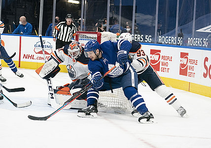 Mar 27, 2021; Toronto, Ontario, CAN; Toronto Maple Leafs left wing Zach Hyman (11) moves in for a shot on goal ahead of Edmonton Oilers center Ryan Nugent-Hopkins (93) during the first period at Scotiabank Arena. Mandatory Credit: Nick Turchiaro-USA TODAY Sports