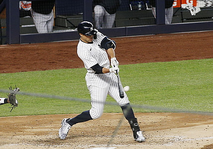 Apr 5, 2021; Bronx, New York, USA; New York Yankees designated hitter Giancarlo Stanton (27) hits a grand slam home run against the Baltimore Orioles during the fifth inning at Yankee Stadium. Mandatory Credit: Andy Marlin-USA TODAY Sports