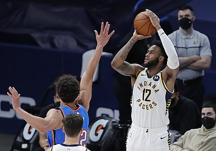 May 1, 2021; Oklahoma City, Oklahoma, USA; Indiana Pacers forward Oshae Brissett (12) shoots a three-point basket as Oklahoma City Thunder center Isaiah Roby (22) defends during the second quarter at Chesapeake Energy Arena. Mandatory Credit: Alonzo Adams-USA TODAY Sports