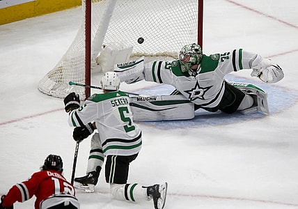 May 9, 2021; Chicago, Illinois, USA; Chicago Blackhawks left wing Alex DeBrincat (12) scores on Dallas Stars goaltender Anton Khudobin (35) during their game at United Center. Mandatory Credit: Eileen T. Meslar-USA TODAY Sports