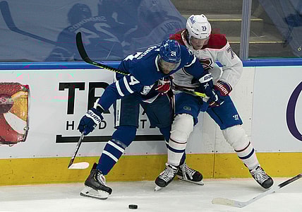 May 22, 2021; Toronto, Ontario, CAN; Toronto Maple Leafs right wing Wayne Simmonds (24) battles for the puck against Montreal Canadiens right wing Tyler Toffoli (73) during the third period in game two of the first round of the 2021 Stanley Cup Playoff at Scotiabank Arena. Mandatory Credit: Nick Turchiaro-USA TODAY Sports