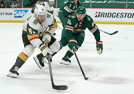 May 22, 2021; Saint Paul, Minnesota, USA; Vegas Golden Knights center Jonathan Marchessault (81) controls the puck against Minnesota Wild defenseman Jonas Brodin (25) during the first period in game four of the first round of the 2021 Stanley Cup Playoffs at Xcel Energy Center. Mandatory Credit: Nick Wosika-USA TODAY Sports