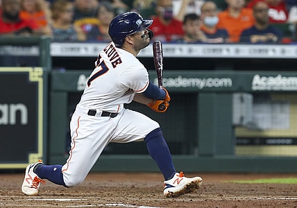 May 31, 2021; Houston, Texas, USA; Houston Astros second baseman Jose Altuve (27) hits a two run home run against the Boston Red Sox in the third inning at Minute Maid Park. Mandatory Credit: Thomas Shea-USA TODAY Sports