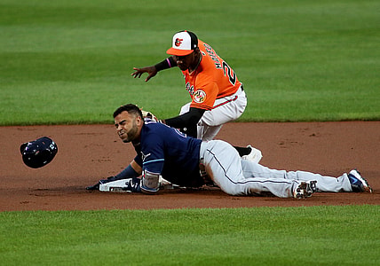 Aug 7, 2021; Baltimore, Maryland, USA; Tampa Bay Rays designated hitter Nelson Cruz (23) slides in safely to second base against Baltimore Orioles shortstop Jorge Mateo (26) during the first inning at Oriole Park at Camden Yards. Mandatory Credit: Daniel Kucin Jr.-USA TODAY Sports