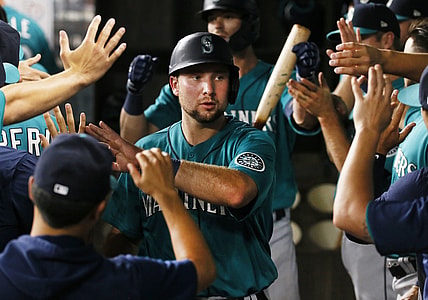 Aug 17, 2021; Arlington, Texas, USA; Seattle Mariners catcher Cal Raleigh (29) is greeted in the dugout after scoring against the Texas Rangers during the fifth inning at Globe Life Field. Mandatory Credit: Raymond Carlin III-USA TODAY Sports