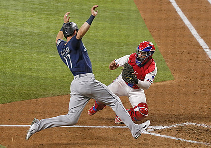 Aug 18, 2021; Arlington, Texas, USA; Texas Rangers catcher Jose Trevino (right) tags out Seattle Mariners right fielder Mitch Haniger (17) as Haniger tries to score during the sixth inning at Globe Life Field. Mandatory Credit: Raymond Carlin III-USA TODAY Sports