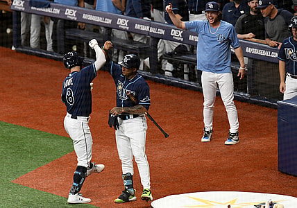 Aug 30, 2021; St. Petersburg, Florida, USA; Tampa Bay Rays second baseman Brandon Lowe (8) celebrates with shortstop Wander Franco (5) after hitting a solo home run in the first inning against the Boston Red Sox  at Tropicana Field. Mandatory Credit: Jonathan Dyer-USA TODAY Sports