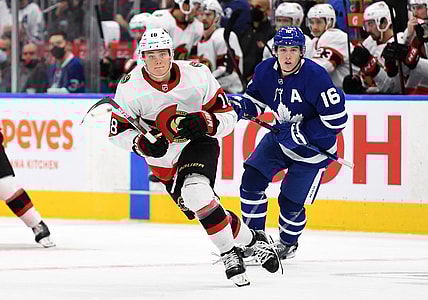 Oct 9, 2021; Toronto, Ontario, CAN;   Ottawa Senators forward Tim Stutzle (18) pursues the play ahead of Toronto Maple Leafs forward Mitch Marner (16) in the third period at Scotiabank Arena. Mandatory Credit: Dan Hamilton-USA TODAY Sports