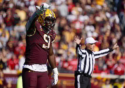 Oct 16, 2021; Minneapolis, Minnesota, USA;  Minnesota Golden Gophers defensive linemen Esezi Otomewo (9) celebrates a stop against the Nebraska Cornhuskers on fourth down during the fourth quarter at Huntington Bank Stadium. Mandatory Credit: Nick Wosika-USA TODAY Sports